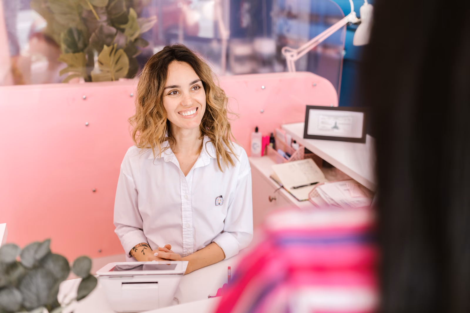 A clinic receptionist welcoming a client