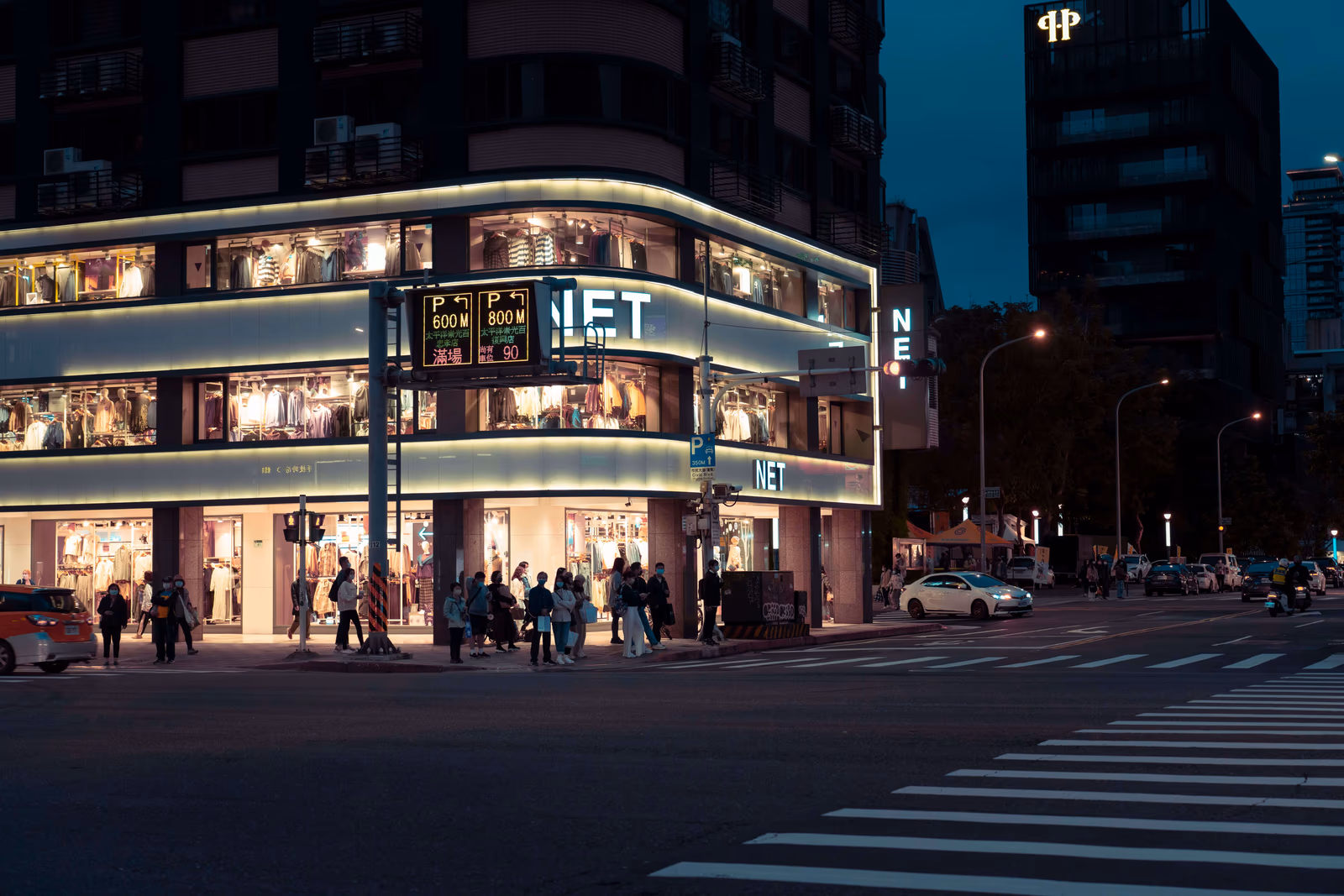 An illuminated shopping mall in the evening