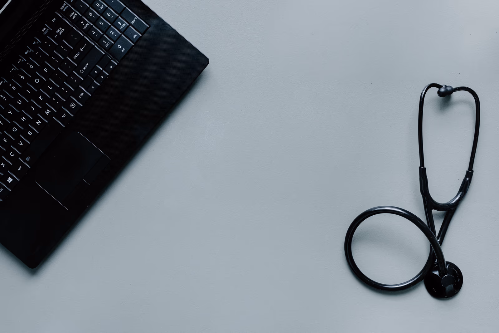 A laptop and stethoscope representing a modern pharmacy website